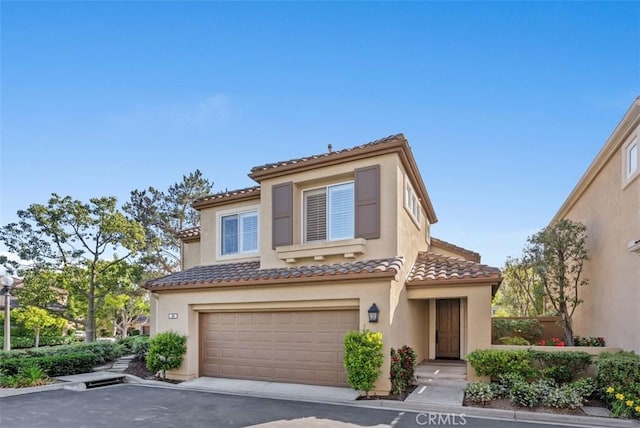 20 Fecamp, Newport Coast, CA 92657 - mediterranean / spanish-style home with an attached garage, a tile roof, stucco siding, and asphalt driveway