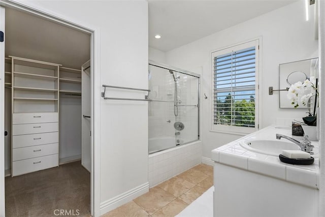 20 Fecamp, Newport Coast, CA 92657 - full bathroom with tiled shower / bath combo, double vanity, baseboards, recessed lighting, and a spacious closet