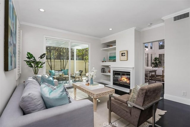 20 Fecamp, Newport Coast, CA 92657 - living room featuring built in features, crown molding, baseboards, a glass covered fireplace, and dark wood-style flooring