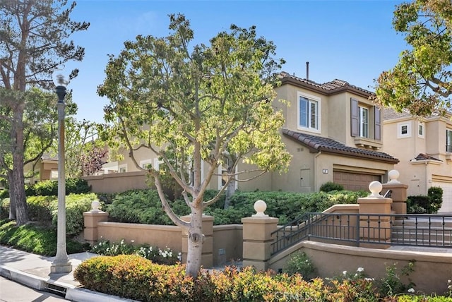 20 Fecamp, Newport Coast, CA 92657 - view of front of property featuring a fenced front yard, a tile roof, stucco siding, and a garage