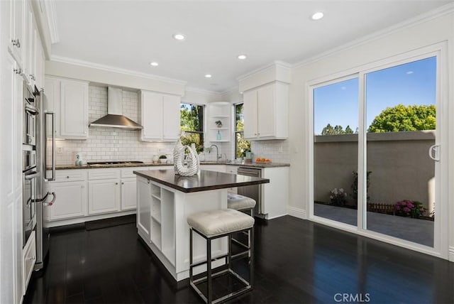 20 Fecamp, Newport Coast, CA 92657 - kitchen with open shelves, wall chimney exhaust hood, dark countertops, dark wood finished floors, and a breakfast bar