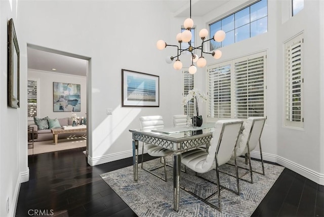 20 Fecamp, Newport Coast, CA 92657 - dining room with wood finished floors, baseboards, a towering ceiling, a chandelier, and a desk