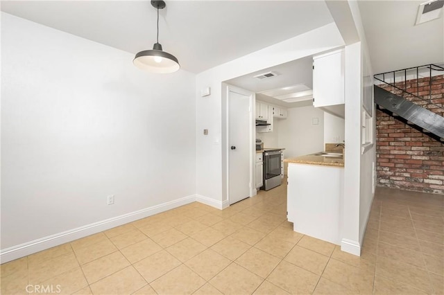 26406 Paseo Pamela, San Juan Capistrano, CA 92675 - kitchen with stainless steel electric stove, white cabinets, baseboards, a sink, and light tile patterned flooring