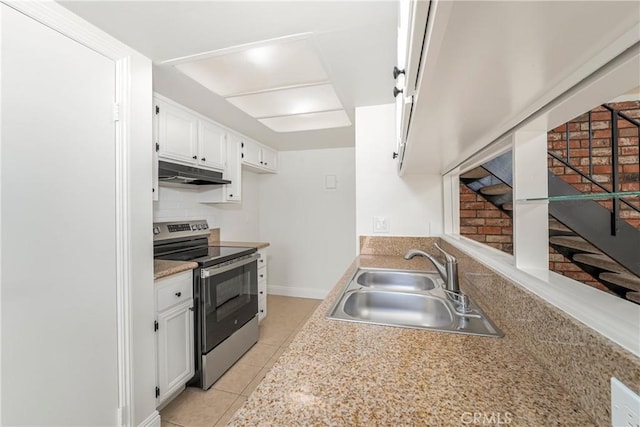 26406 Paseo Pamela, San Juan Capistrano, CA 92675 - kitchen with stainless steel electric stove, a sink, under cabinet range hood, light tile patterned floors, and white cabinets