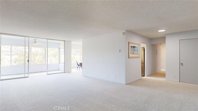 649 Paseo De La Playa Unit 303, Redondo Beach, CA 90277 - carpeted spare room featuring a textured ceiling, ceiling fan, and expansive windows