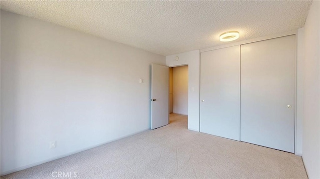 649 Paseo De La Playa Unit 303, Redondo Beach, CA 90277 - unfurnished bedroom with carpet, a closet, and a textured ceiling