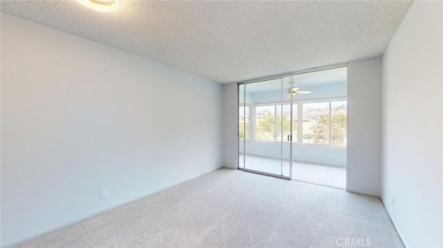 649 Paseo De La Playa Unit 303, Redondo Beach, CA 90277 - carpeted empty room featuring a textured ceiling and floor to ceiling windows