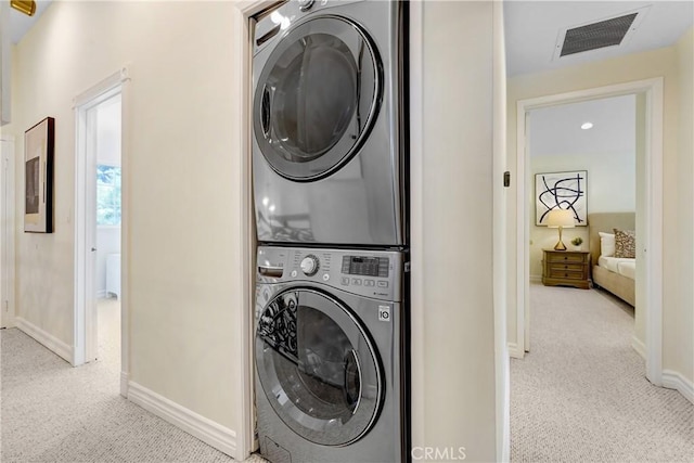 17043 Empanada Pl, Encino, CA 91436 - laundry room with stacked washer and clothes dryer and light colored carpet
