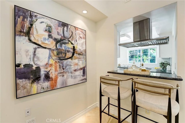17043 Empanada Pl, Encino, CA 91436 - bar featuring wall chimney exhaust hood, recessed lighting, backsplash, and light tile patterned floors