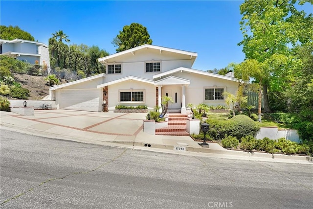 17043 Empanada Pl, Encino, CA 91436 - view of front of property with concrete driveway, a garage, and stucco siding