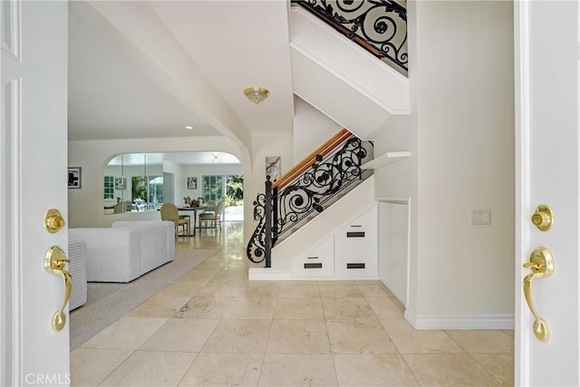 17043 Empanada Pl, Encino, CA 91436 - foyer featuring stairs, arched walkways, and ornamental molding
