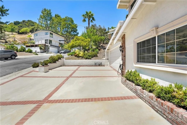 17043 Empanada Pl, Encino, CA 91436 - view of patio / terrace with concrete driveway and an attached garage