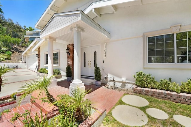 17043 Empanada Pl, Encino, CA 91436 - entrance to property with a porch, a garage, and stucco siding