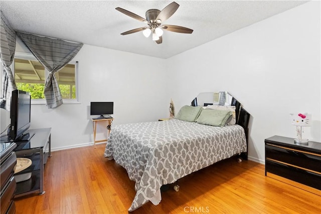 945 W Bonnie Brae Ct, Ontario, CA 91762 - bedroom with wood finished floors, baseboards, ceiling fan, and a textured ceiling