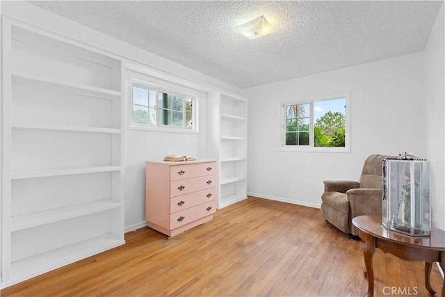 945 W Bonnie Brae Ct, Ontario, CA 91762 - sitting room with a textured ceiling, light wood-style floors, healthy amount of natural light, and baseboards