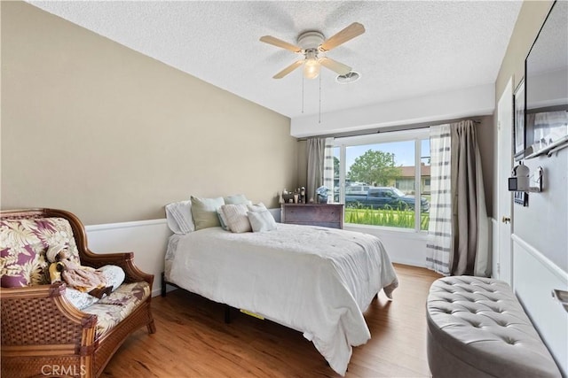 945 W Bonnie Brae Ct, Ontario, CA 91762 - bedroom with wood finished floors, a textured ceiling, and a ceiling fan