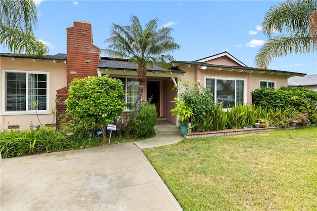 945 W Bonnie Brae Ct, Ontario, CA 91762 - single story home with a front lawn, stucco siding, and a chimney