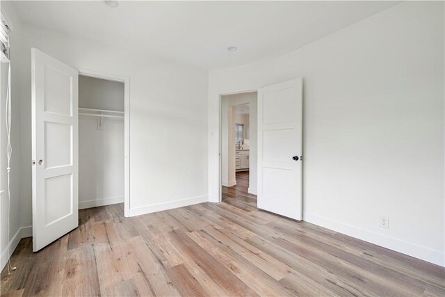 4427 Exposition Blvd, Los Angeles, CA 90016 - unfurnished bedroom with baseboards, light wood-style flooring, and a closet