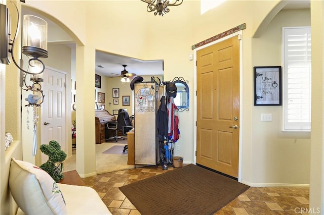 841 Bermuda Dr, Hemet, CA 92543 - foyer featuring arched walkways, stone finish floors, and baseboards