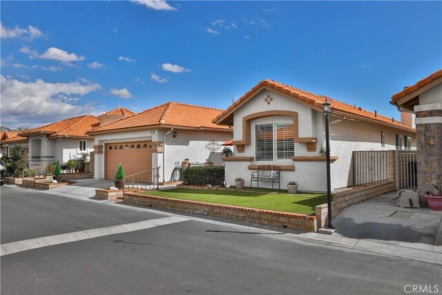 841 Bermuda Dr, Hemet, CA 92543 - mediterranean / spanish house with stucco siding, a garage, a tile roof, and a front lawn