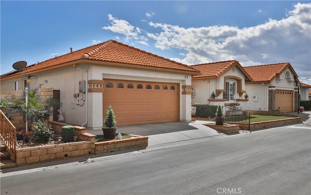 841 Bermuda Dr, Hemet, CA 92543 - mediterranean / spanish home featuring an attached garage, stucco siding, asphalt driveway, and a tiled roof