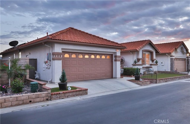 841 Bermuda Dr, Hemet, CA 92543 - mediterranean / spanish home featuring a garage, concrete driveway, stucco siding, and a tile roof