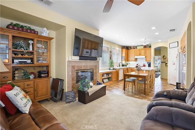 841 Bermuda Dr, Hemet, CA 92543 - living area featuring ceiling fan, a tiled fireplace, recessed lighting, and arched walkways