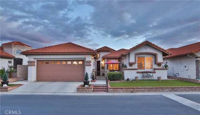 841 Bermuda Dr, Hemet, CA 92543 - mediterranean / spanish-style house with driveway, an attached garage, stucco siding, and a tiled roof