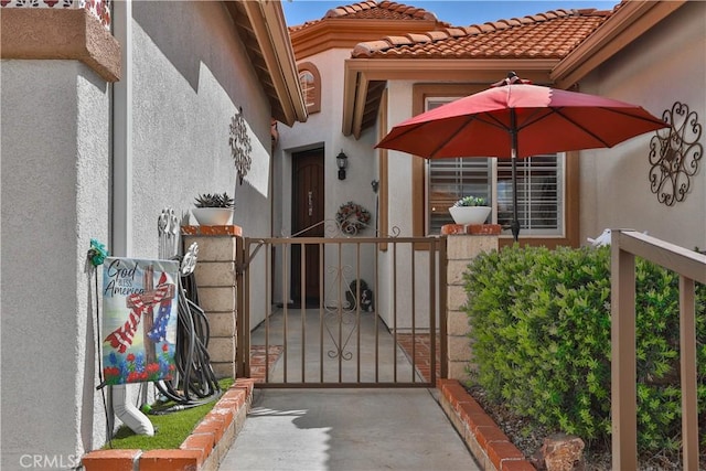 841 Bermuda Dr, Hemet, CA 92543 - doorway to property featuring stucco siding, a gate, and a tiled roof
