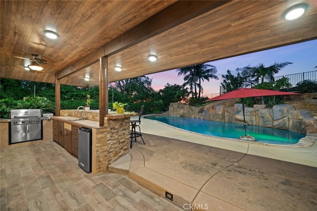 4187 Pepper Ave, Yorba Linda, CA 92886 - patio terrace at dusk with area for grilling, an outdoor pool, a patio area, and ceiling fan