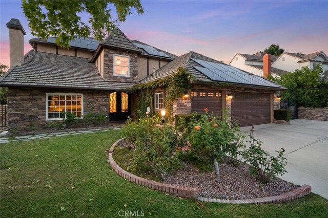 4187 Pepper Ave, Yorba Linda, CA 92886 - tudor home with stone siding, a garage, driveway, and a yard