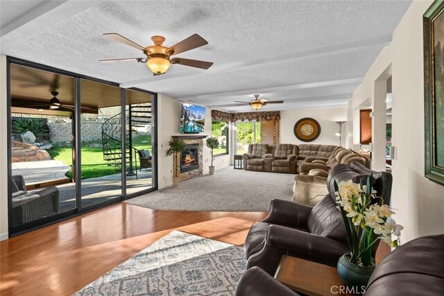 4187 Pepper Ave, Yorba Linda, CA 92886 - living area featuring ceiling fan, a textured ceiling, wood finished floors, and a warm lit fireplace