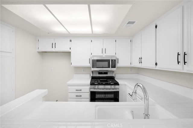 625 E Merion St, Ontario, CA 91761 - kitchen with stainless steel appliances, light countertops, white cabinetry, and a sink
