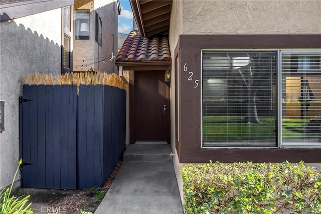 625 E Merion St, Ontario, CA 91761 - doorway to property featuring stucco siding and a tiled roof