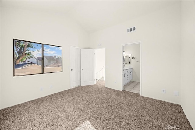 625 E Merion St, Ontario, CA 91761 - unfurnished bedroom featuring light colored carpet, high vaulted ceiling, and connected bathroom