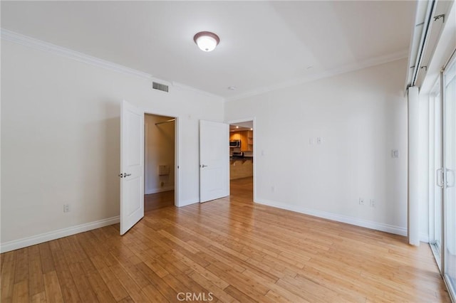 3061 W 12th Pl Unit 101, Los Angeles, CA 90006 - unfurnished bedroom featuring ornamental molding, light wood finished floors, and baseboards