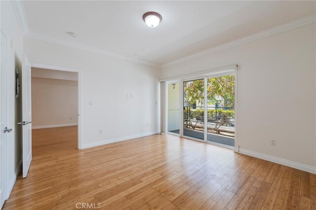 3061 W 12th Pl Unit 101, Los Angeles, CA 90006 - unfurnished room with crown molding, baseboards, and light wood-style floors