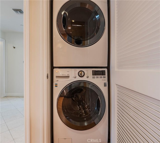 3061 W 12th Pl Unit 101, Los Angeles, CA 90006 - laundry area featuring estacked washer and dryer and light tile patterned floors