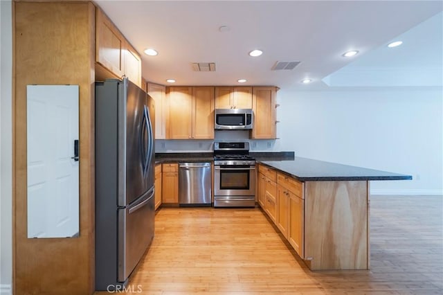 3061 W 12th Pl Unit 101, Los Angeles, CA 90006 - kitchen featuring stainless steel appliances, a peninsula, recessed lighting, light wood finished floors, and baseboards