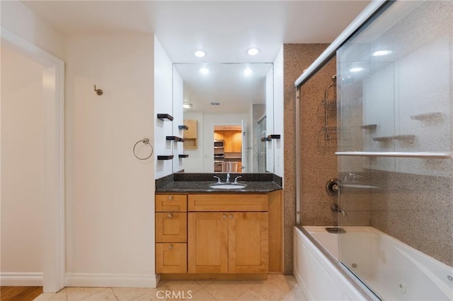 3061 W 12th Pl Unit 101, Los Angeles, CA 90006 - full bathroom with vanity, a combined bath / shower with jetted tub, tile patterned floors, recessed lighting, and baseboards