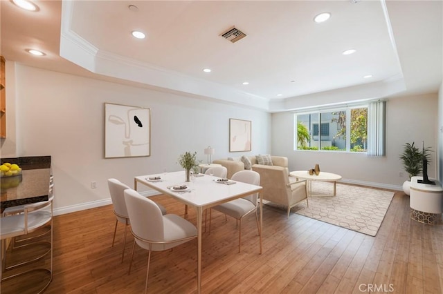 3061 W 12th Pl Unit 101, Los Angeles, CA 90006 - dining space with a raised ceiling, baseboards, wood-type flooring, ornamental molding, and recessed lighting