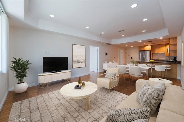 3061 W 12th Pl Unit 101, Los Angeles, CA 90006 - living room with a tray ceiling, ornamental molding, light wood-type flooring, recessed lighting, and baseboards