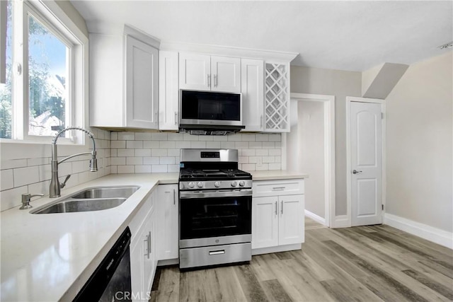 1835 Martin Luther King Blvd, Riverside, CA 92507 - kitchen featuring stainless steel appliances, a sink, light countertops, and light wood finished floors