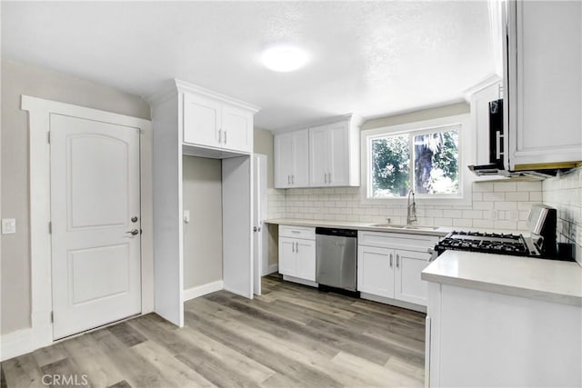 1835 Martin Luther King Blvd, Riverside, CA 92507 - kitchen featuring stainless steel dishwasher, a sink, black gas range, tasteful backsplash, and white cabinets
