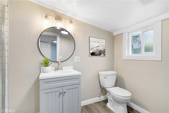 1835 Martin Luther King Blvd, Riverside, CA 92507 - bathroom featuring vanity, wood finished floors, toilet, and baseboards