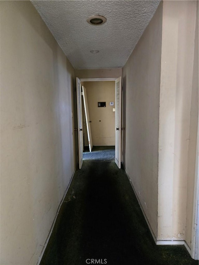 5738 S Mullen Ave, Los Angeles, CA 90043 - hallway featuring a textured ceiling