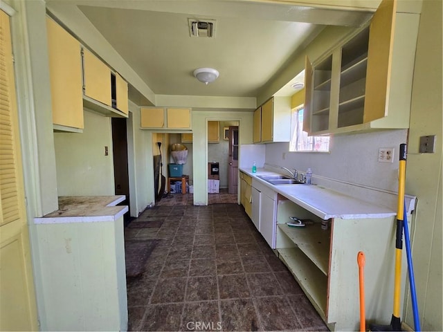 5738 S Mullen Ave, Los Angeles, CA 90043 - kitchen featuring open shelves, dark stone finish floors, light countertops, and a sink