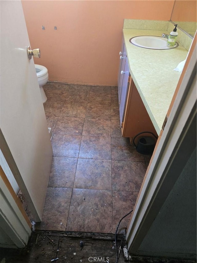 5738 S Mullen Ave, Los Angeles, CA 90043 - bathroom with toilet, vanity, and stone finish floors
