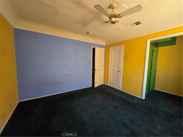 5738 S Mullen Ave, Los Angeles, CA 90043 - spare room featuring a textured ceiling, a ceiling fan, and dark colored carpet
