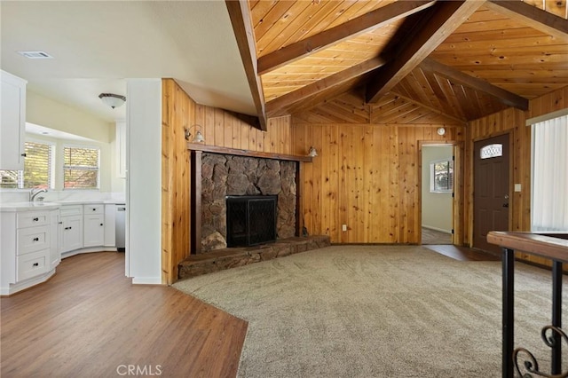 32296 Fern Dr, Running Springs, CA 92382 - unfurnished living room with a fireplace, wooden walls, light wood-type flooring, wooden ceiling, and a sink